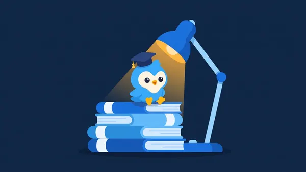 Pip, the blue bird mascot, with a graduation cap sitting on a stack of blue books, a desk lamp glowing amber